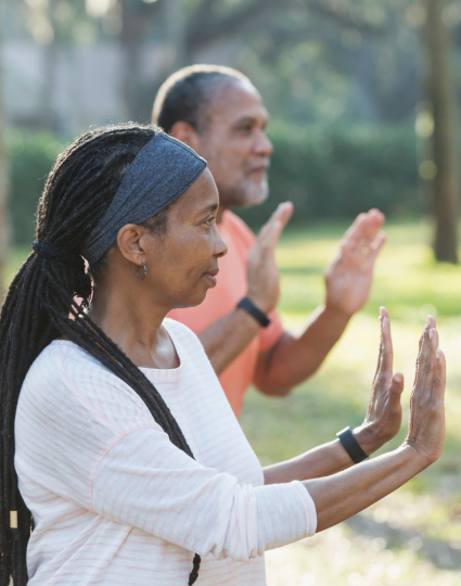 Older adult woman and man practicing Tai Chi