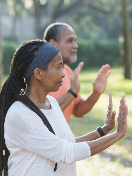 Older adult woman and man practicing Tai Chi