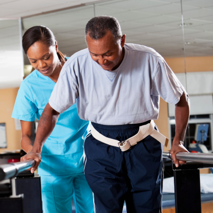 Physical Therapist assisting an elderly patient